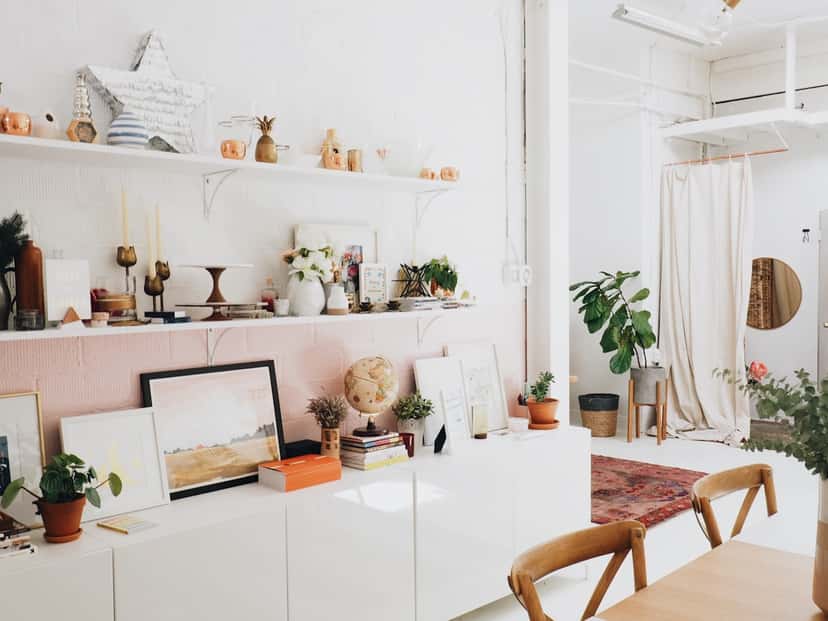 Mixed-size prints styled around a bright room, anchor-and-satellite style