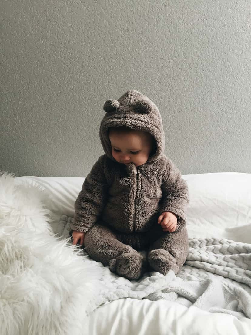 Baby in a bear onesie, the kind of playful subject nursery canvas art is made for